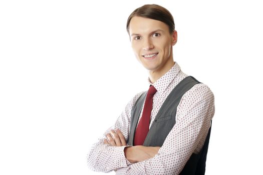 Young smiling businessman with arms crossed on a white background