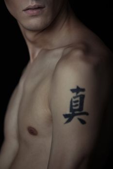 Man with tattoo on a black background