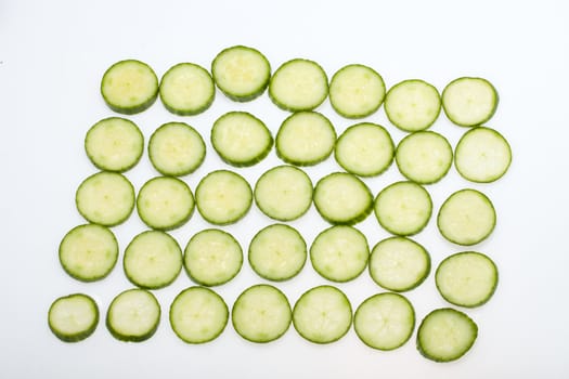 Freshly sliced cucumber  isolated on white background 