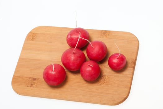 Garden radish on wooden board 