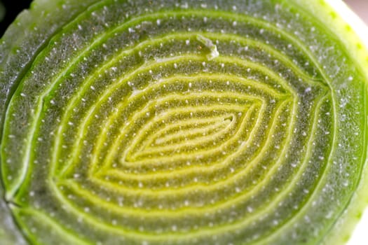 Closeup of a chopped leek on a wooden board in a kitchen