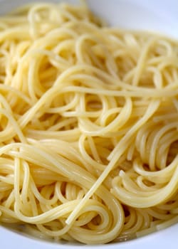 unseasoned spaghetti on a white dish
