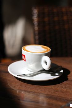 Illy coffee cup on the table of an italian bar. Hungarian born Francesco Illy first came to Trieste, Italy after World War I. There he studied economics, and he returned and found a business in cocoa and coffee wich would become its sole focus.