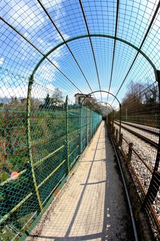 long pedestrian tunnel near by the train railway in Belluno