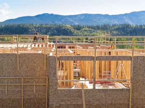 Urban development concept  new build rural house under construction with view of wooden framework interior will block out beautiful wilderness landscape scenery in background when completed