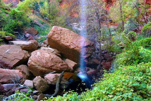 Waterfall flows into the Lower Emerald Pools of Zion National Park in Utah.