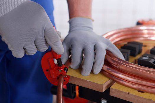 craftsman cutting a pipe