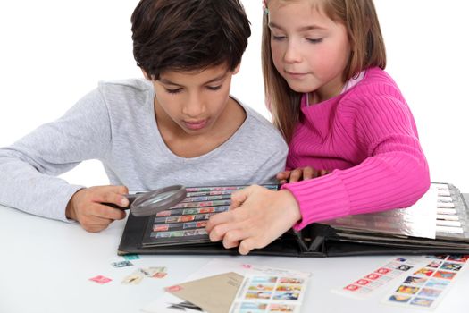 Children looking at a stamp album