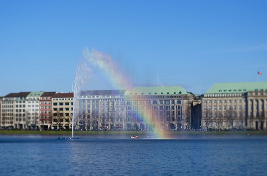 Rainbow effect on the Alster fountain in Hamburg. Lens blur.