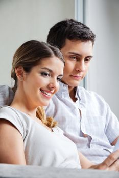 Happy young woman sitting with boyfriend