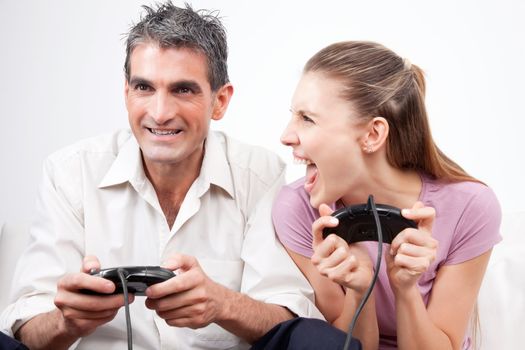 Excited couple playing computer games .