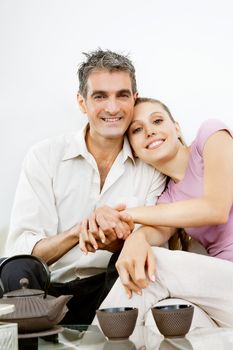 Portrait of happy couple sitting together while holding hands