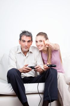 Couple playing computer games, woman pointing.