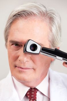Eye doctor optometrist with opthalmoscope.