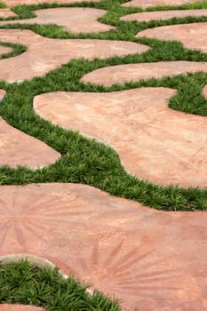 Cement walkways decorated with grass and beautiful. Parks.