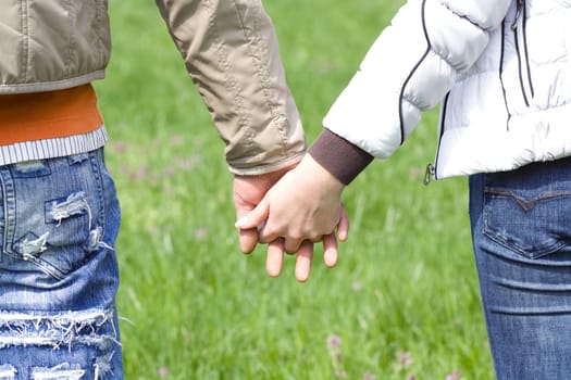 Detailed view of a young couple holding hands