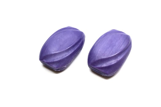 Purple soap used to clean the body. White background.