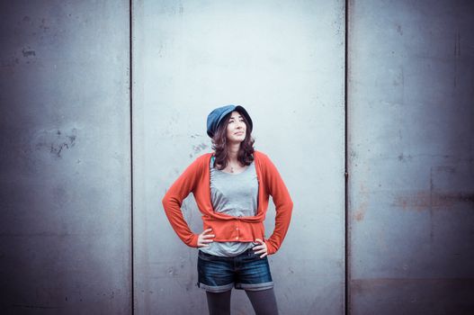 Beautiful stylish woman listening to music in the street 