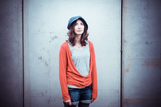 Beautiful stylish woman listening to music in the street 