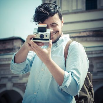 stylish man in the street with old camera in the city