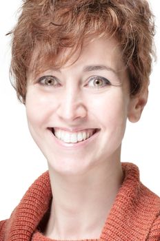 smiling short hair girl cold with orange sweater on white background