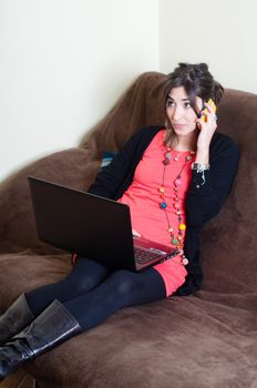 woman at home using notebook on couch