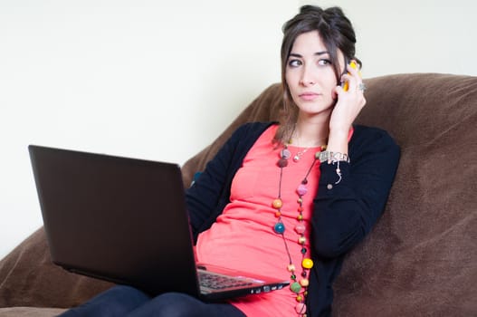 woman at home using notebook on couch