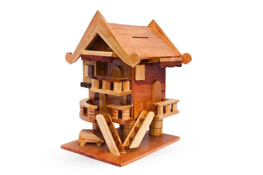 Wooden house on a white background, piggy bank, small savings collections.