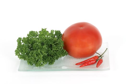 Plate of fresh vegetables - tomato, pepper and herb