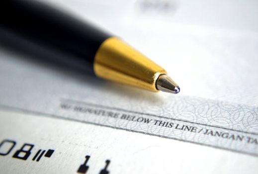 Close up on cheque with a pen