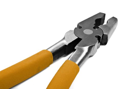 Close up macro of metal pliers with yellow handle