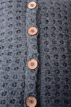 Detail with buttons of a grey cardigan