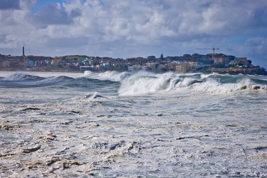 Heavy powerful seas during a cyclone with the wind whipping spray off white breakers at Bondi Beach, Sydney, Australia