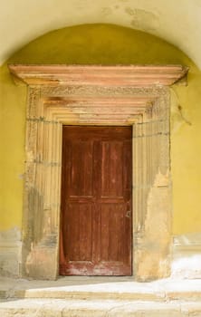 medieval church door on yellow wall