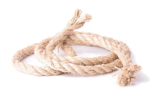 a coil of large diameter natural rope on white background