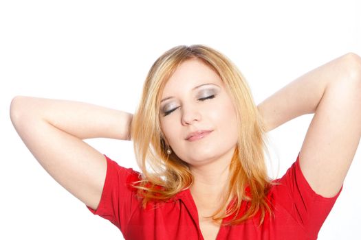 Young woman relaxing standing with her hands clasped behind her head and her eyes closed isolated on white