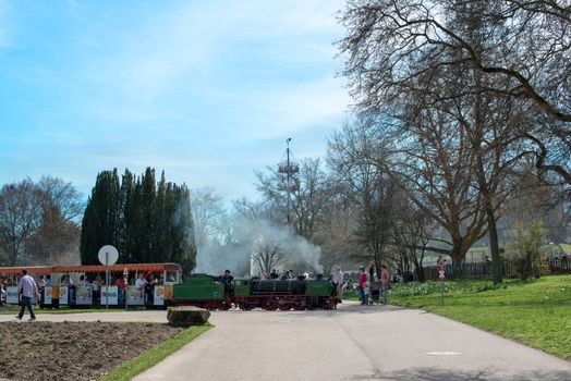 STUTTGART, GERMANY - April 14, 2013: People are enjoying the first sunny spring day in Killesberg Park in Stuttgart, Germany on April 14, 2013. Killesberg Park was opened 1939 and is with its about 50 hectares an important recreation area for inhabitants and a great sight for tourists of Stuttgart.