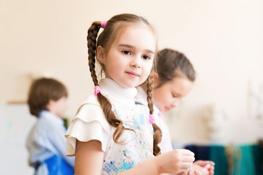 portrait of a girl in an apron, the kids involved in art school