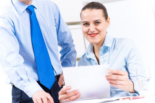 colleagues discuss the reports at a desk in the office, working together in business