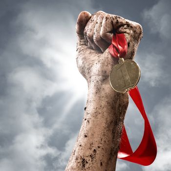 hand holding a winner's medal, success in competitions