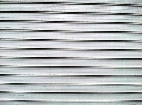 Gray steel garage door with horizontal lines