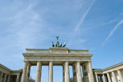 Brandenburg Gate Quadriga (German: Brandenburger Tor), former city gate, landmarks of Germany, on blue sky background