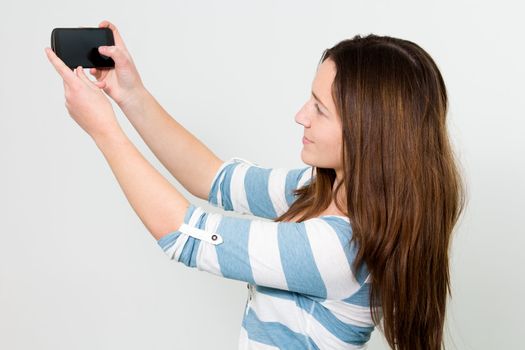 Brunette Girl using touchscreen of a Smartphone