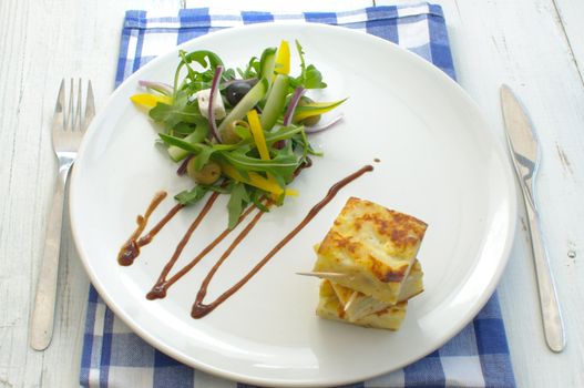 Potato omelette on a plate with a salad 