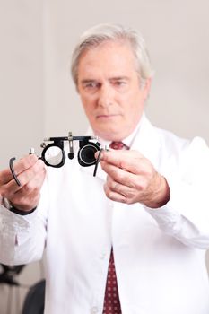 Optometrist holding a eye test glasses.