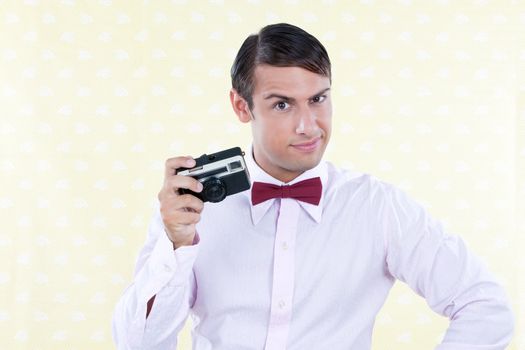 Retro styled man posing with rangefinder camera