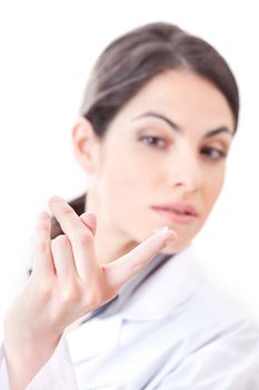 Optometrist holding contact lens in finger.