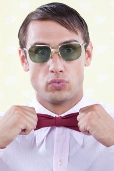 Geeky male adjusting red bow tie