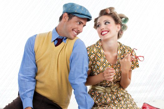 Portrait of retro young couple looking and smiling at eachother
