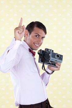 Man holding medium format camera pointing finger upward.